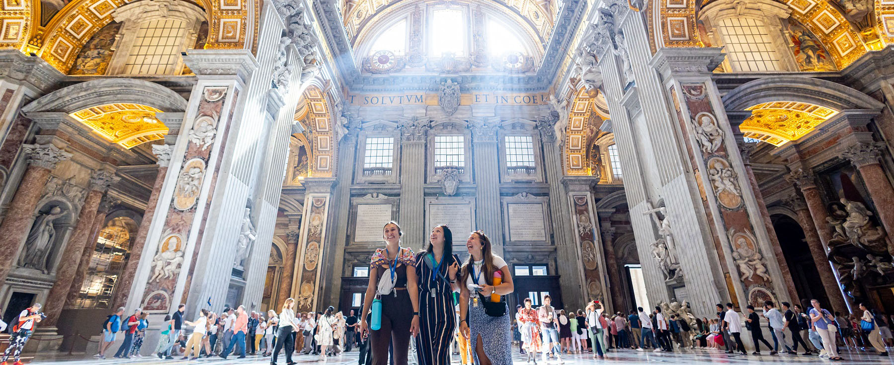 Students admire the ceiling of St Peter's Basilica during an onsite class